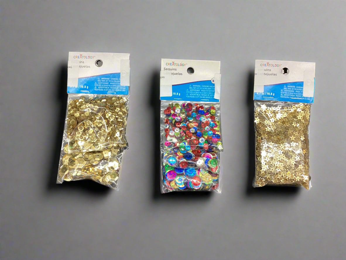 Three packages of decorative stones on a gray background