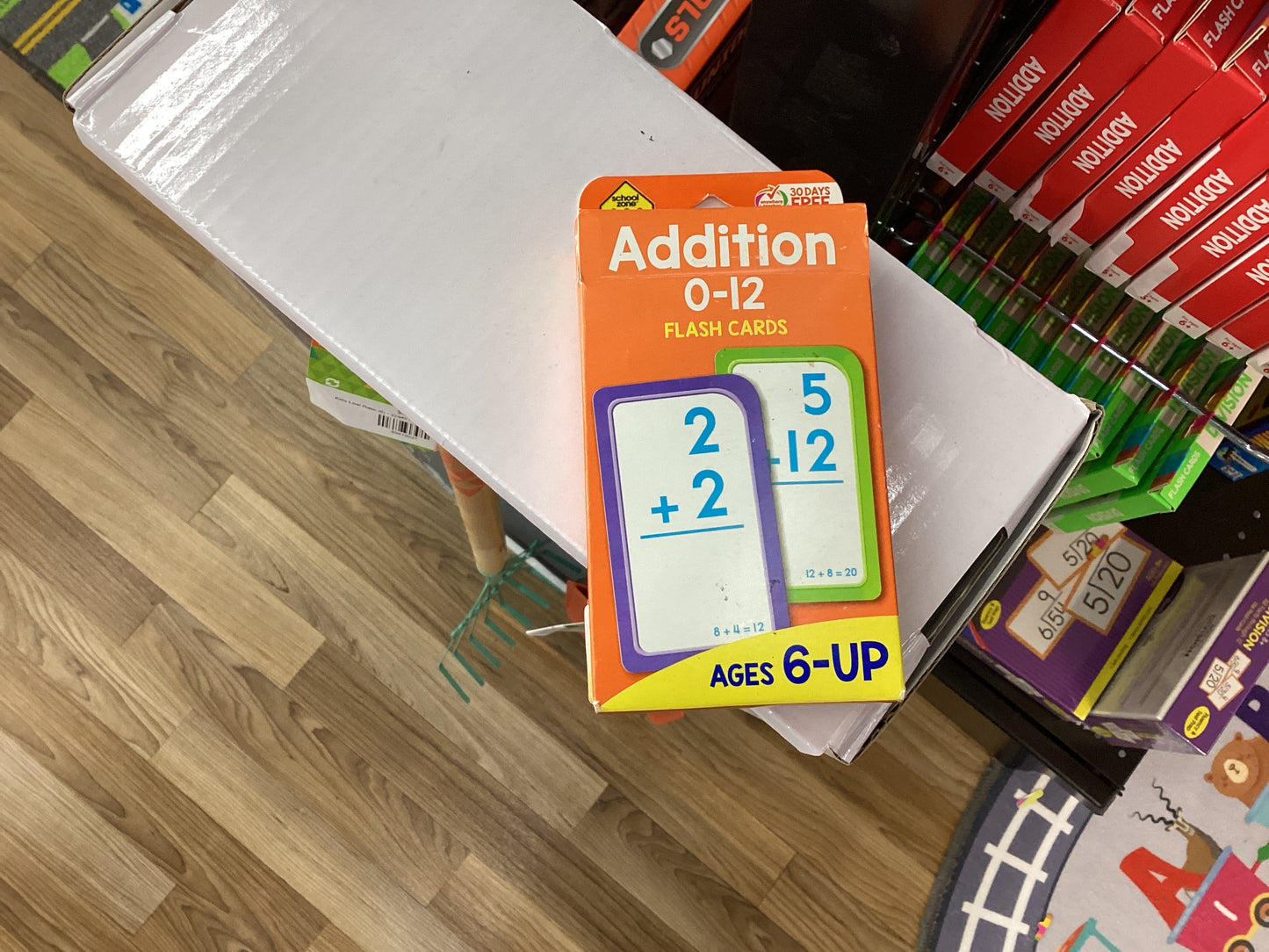 A pack of 'Addition 0-12' flashcards designed for children aged 6 and up, displayed on a table.