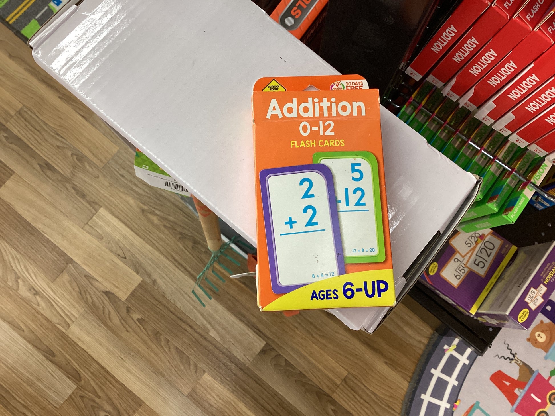 A pack of 'Addition 0-12' flashcards designed for children aged 6 and up, displayed on a table.