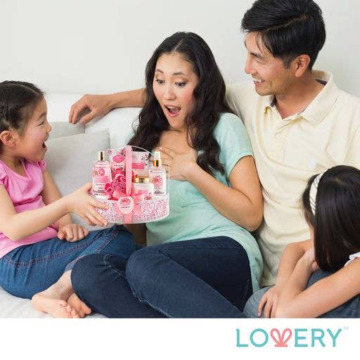 Family of four with a gift basket, sitting on a couch, with LOVERY branding.