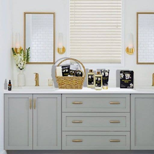 Bathroom vanity with gray cabinets, white countertop, and decorative items including a basket and bottles.