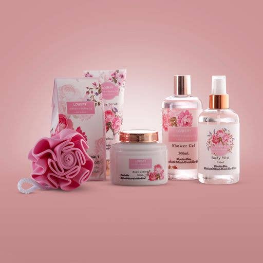 Set of beauty products with floral designs on a pink background
