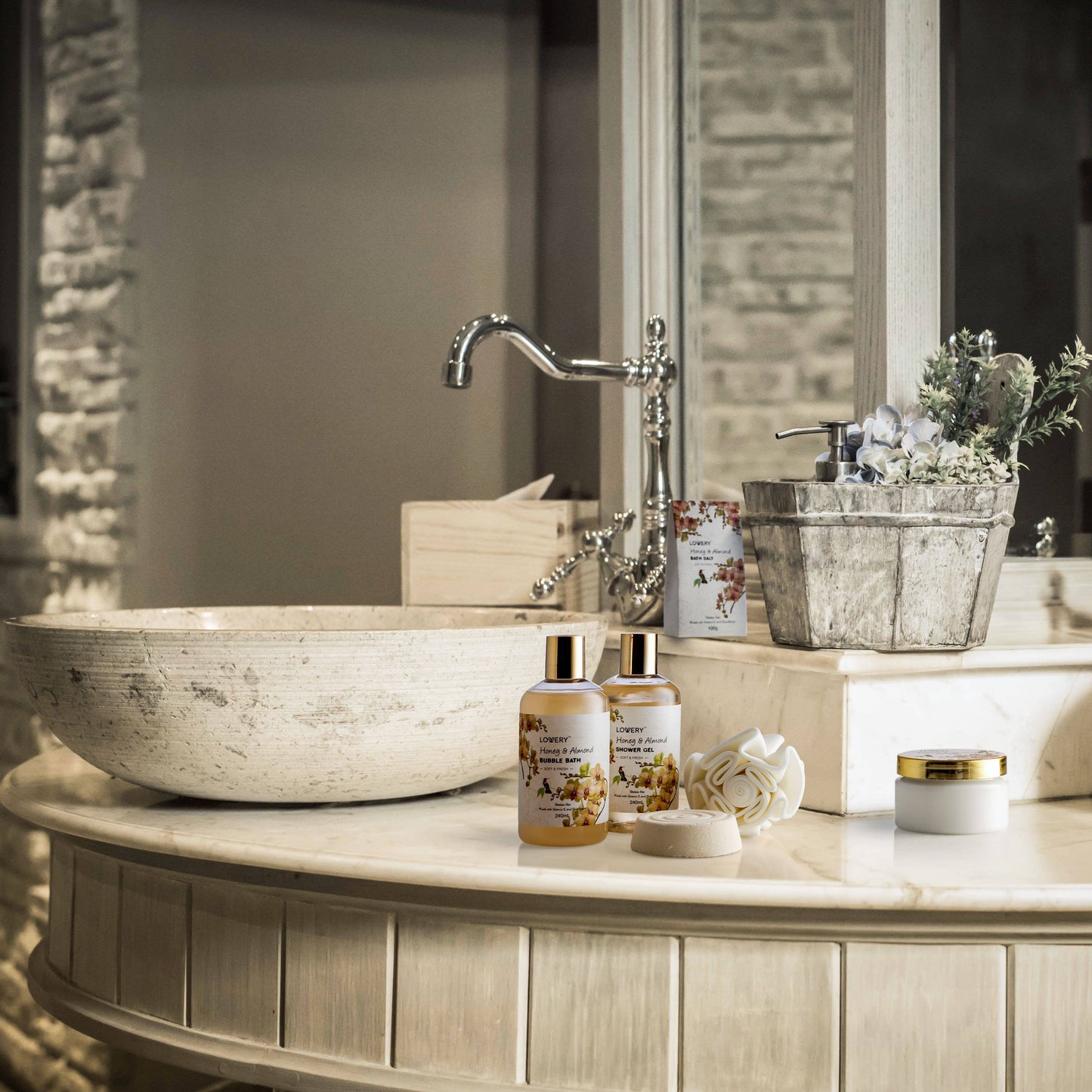 Bathroom counter with stone sink, bottles, and decorative items.